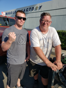 Shayne Smith and his father outside of their auto repair shop