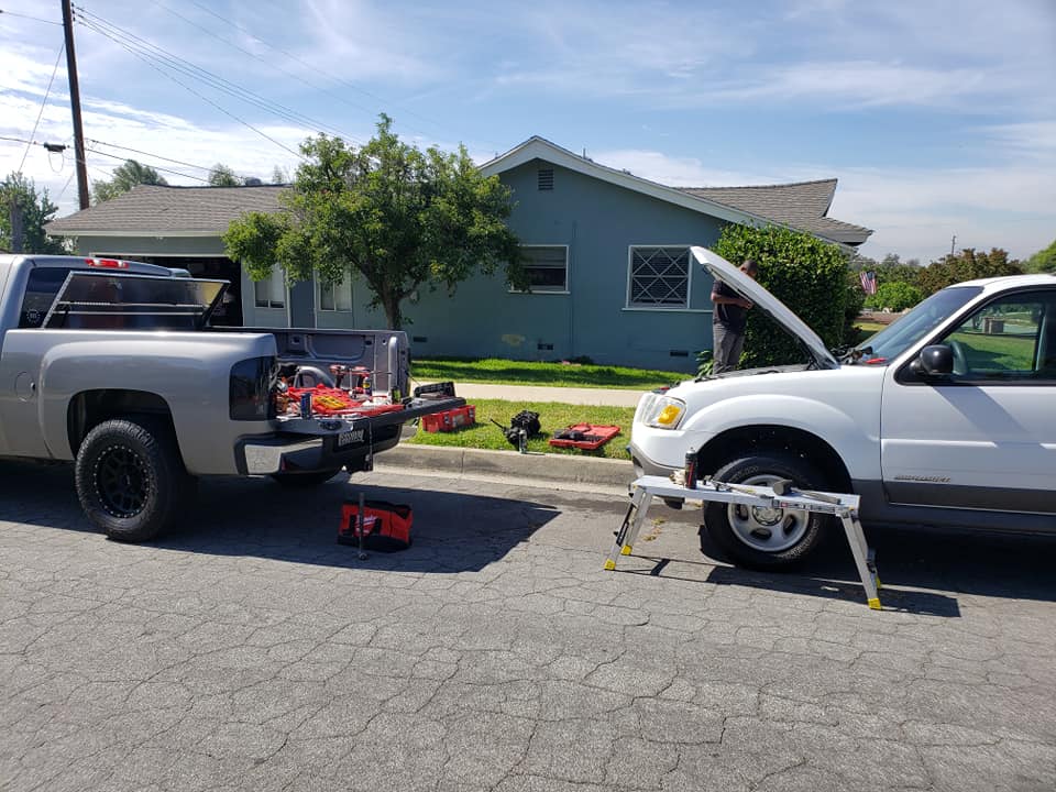A mobile mechnic from MechaMedix performing auto repair at a customer's location